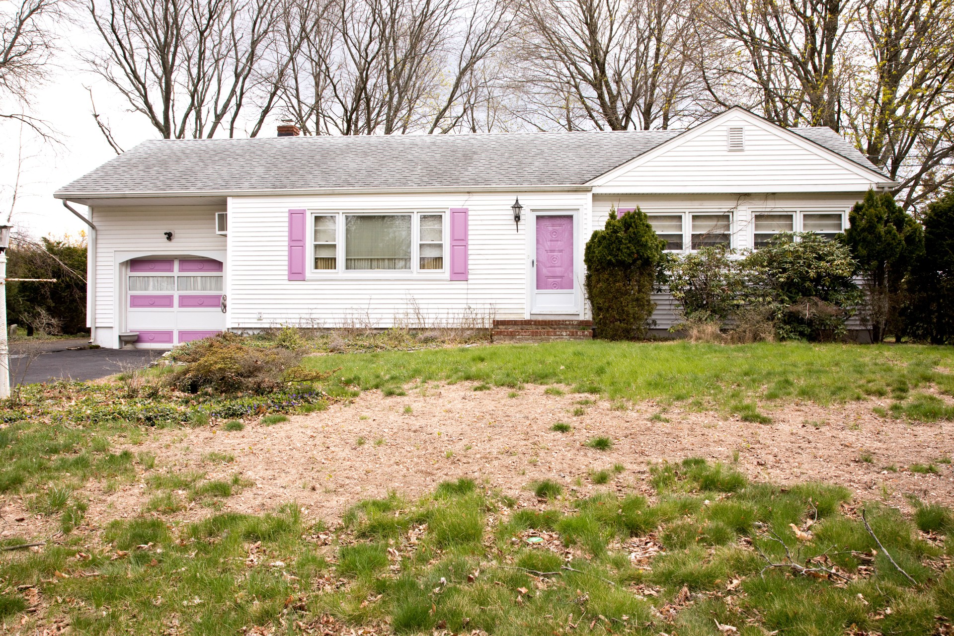 Run down house with dead lawn in foreground